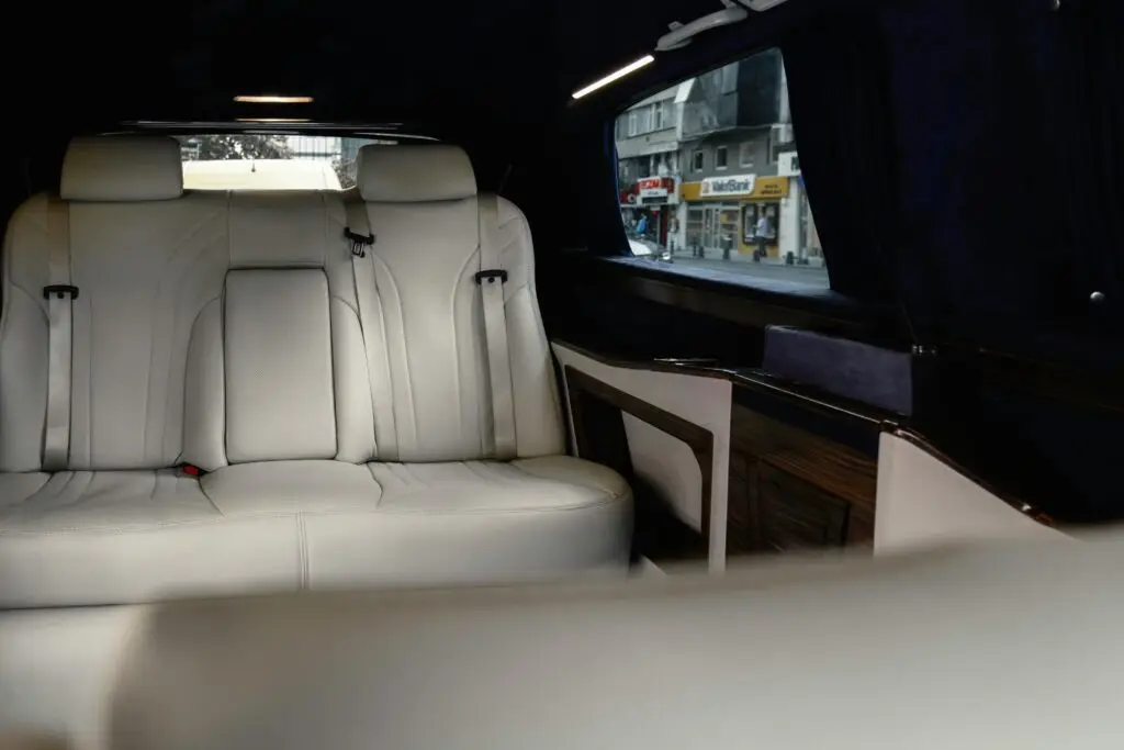 Elegant white leather seats in a Mercedes-Benz V-Class with urban view.